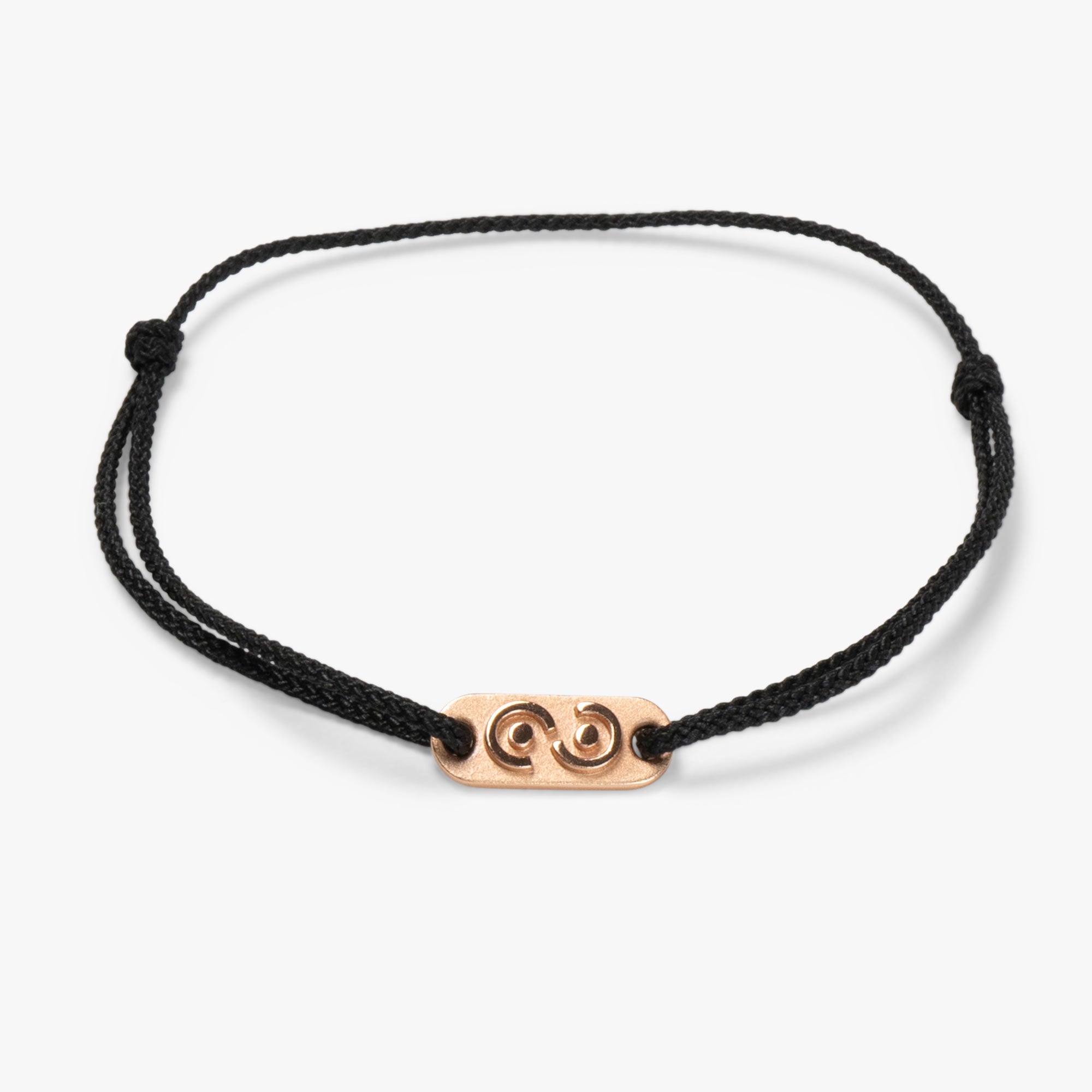 A black polyester bracelet with a 14k rose gold plated tag that features an abstract design of the infinity symbol and a handshake motif.