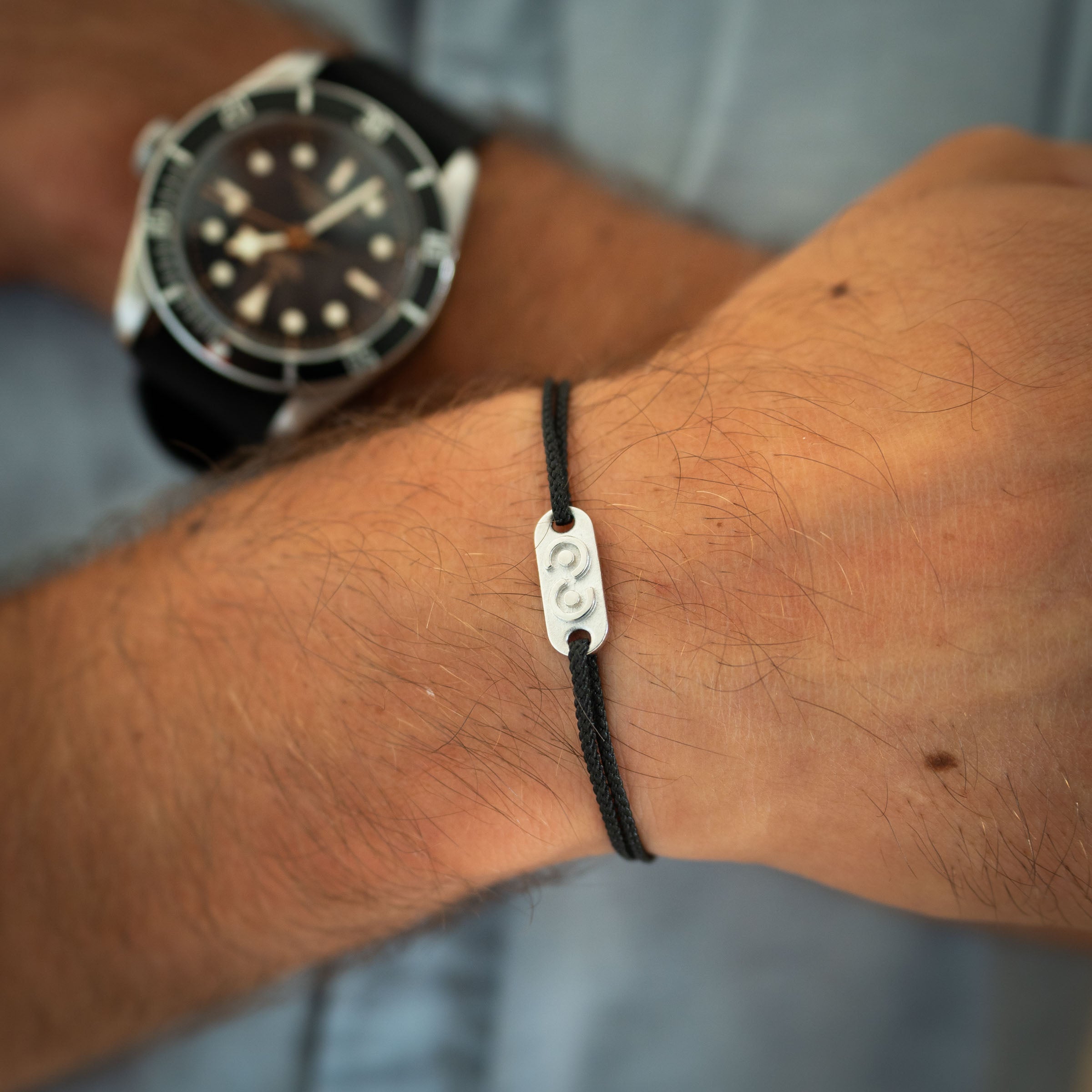 silver tag on black thread for men