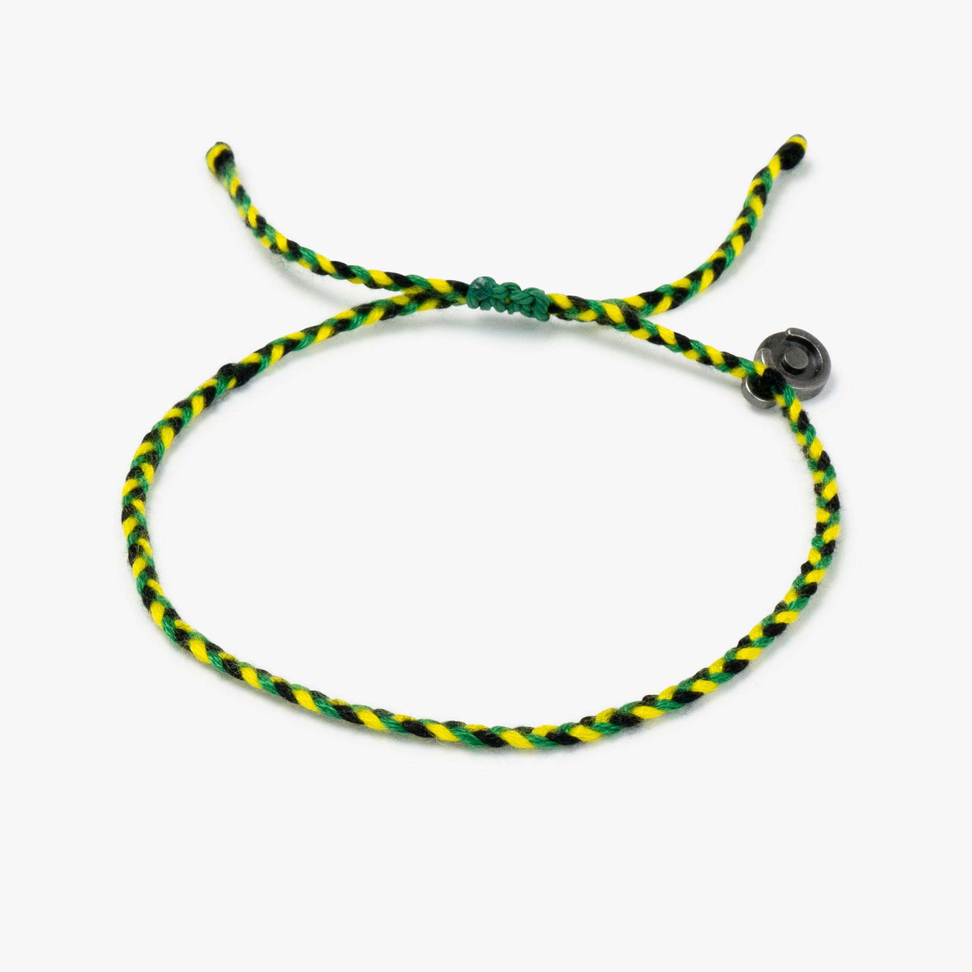 A woven bracelet with green, yellow, and black colors, featuring a gunmetal power pose charm, on a white background.