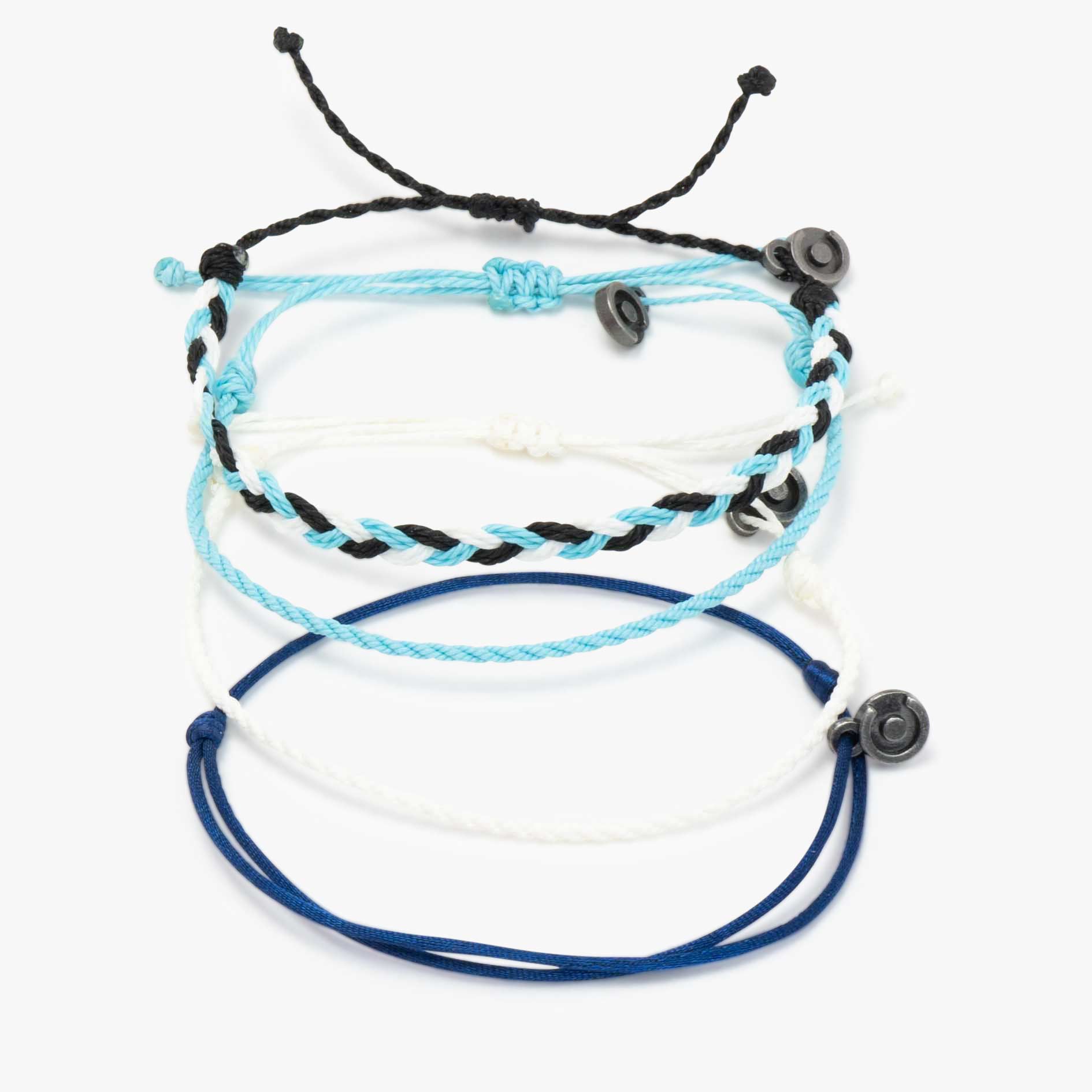 A set of four bracelets laid out on a white surface, featuring a mix of wax-coated polyester and satin materials in black, blue, and white colors, each with a gunmetal charm.