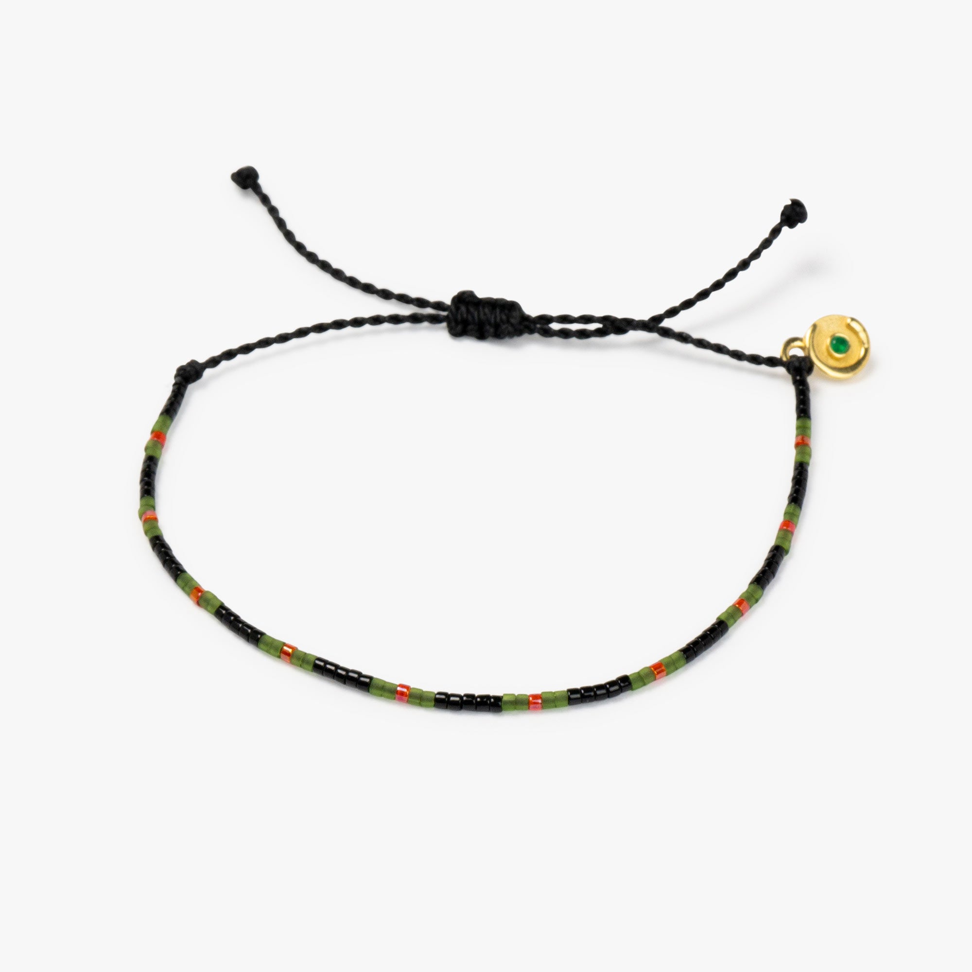 A black and multicolor beaded bracelet with a green zircon stone charm, featuring an adjustable cord.