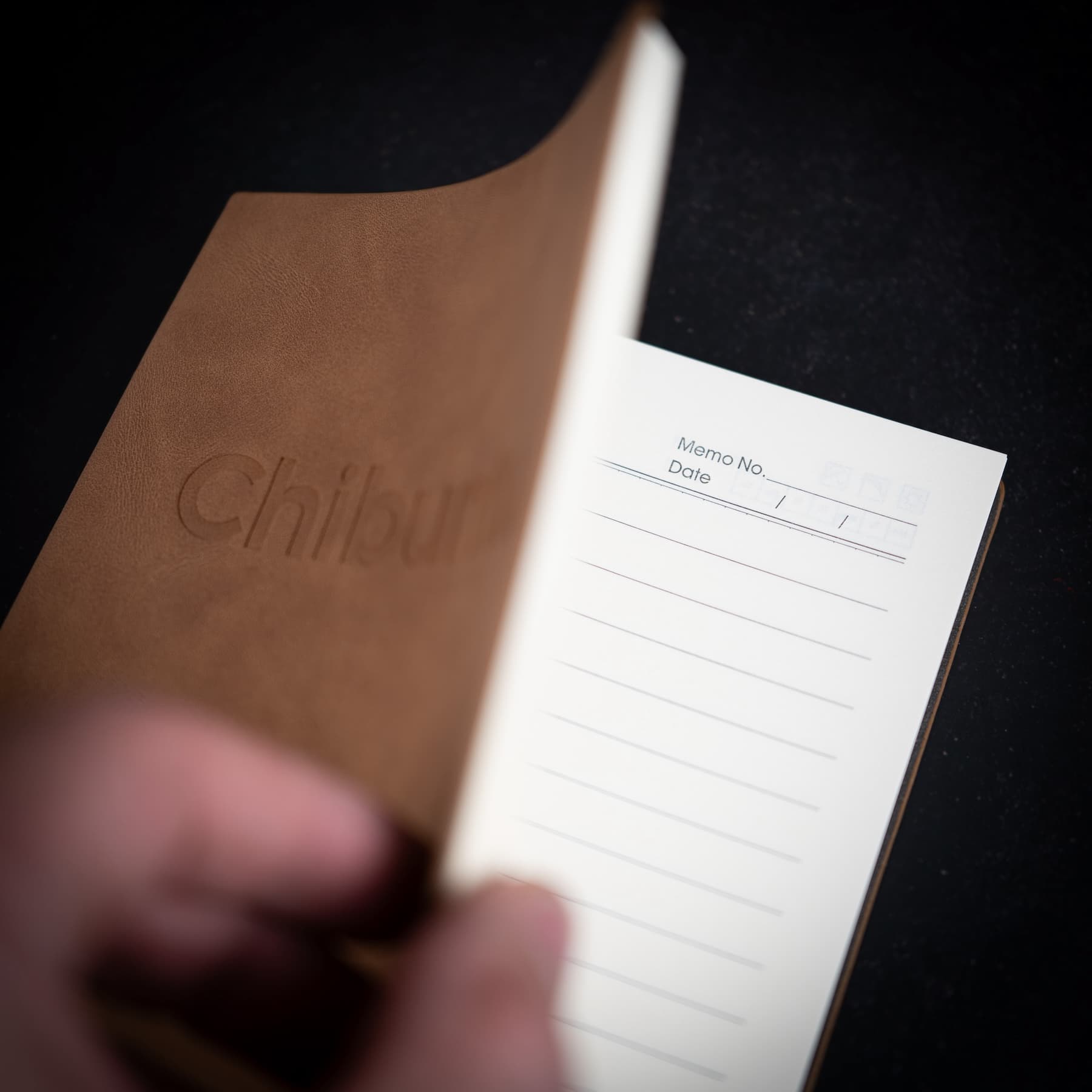 Brown notebook with 'Chiburu' branding on a black background
