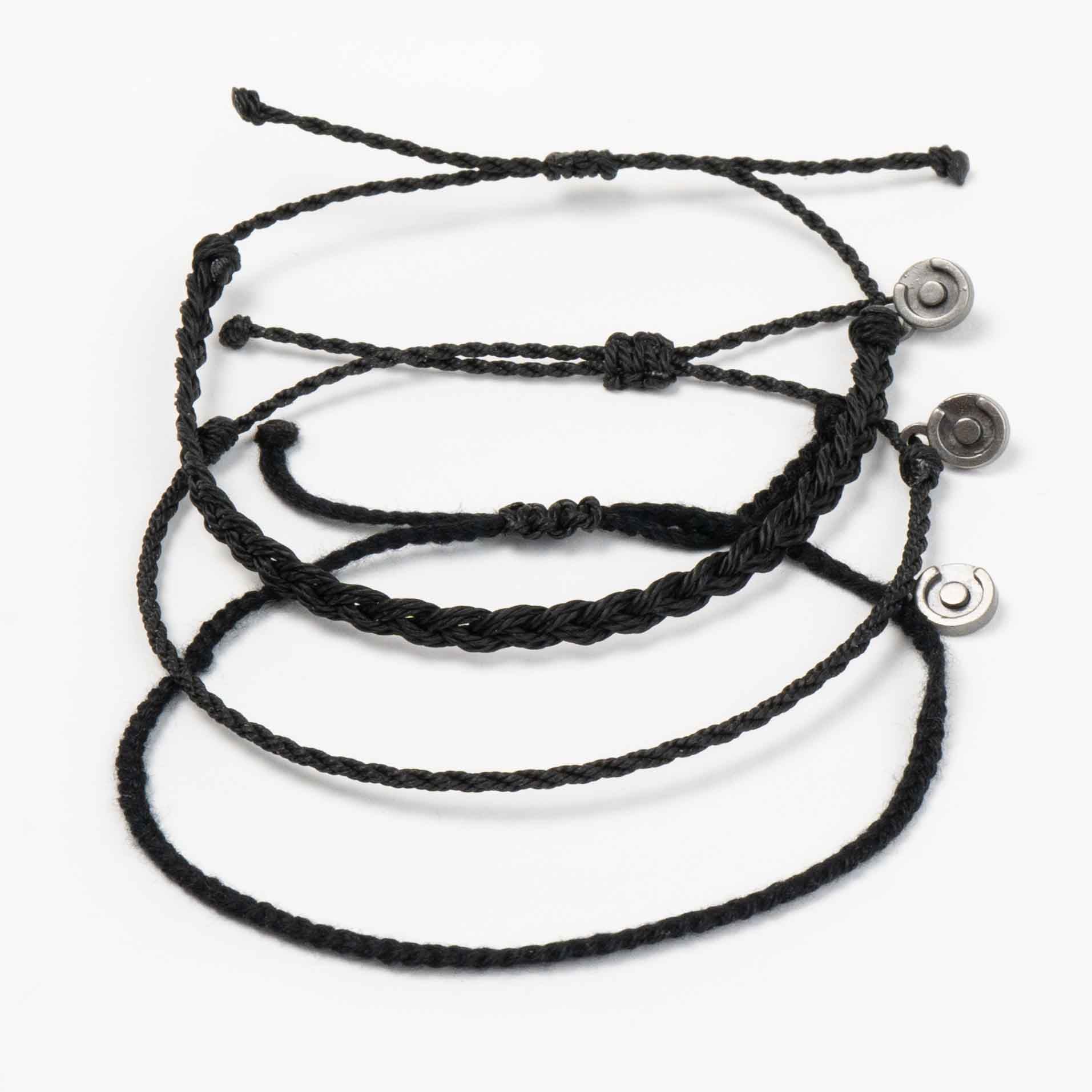 Three black wax-coated polyester bracelets with gunmetal charms, displayed against a white background.