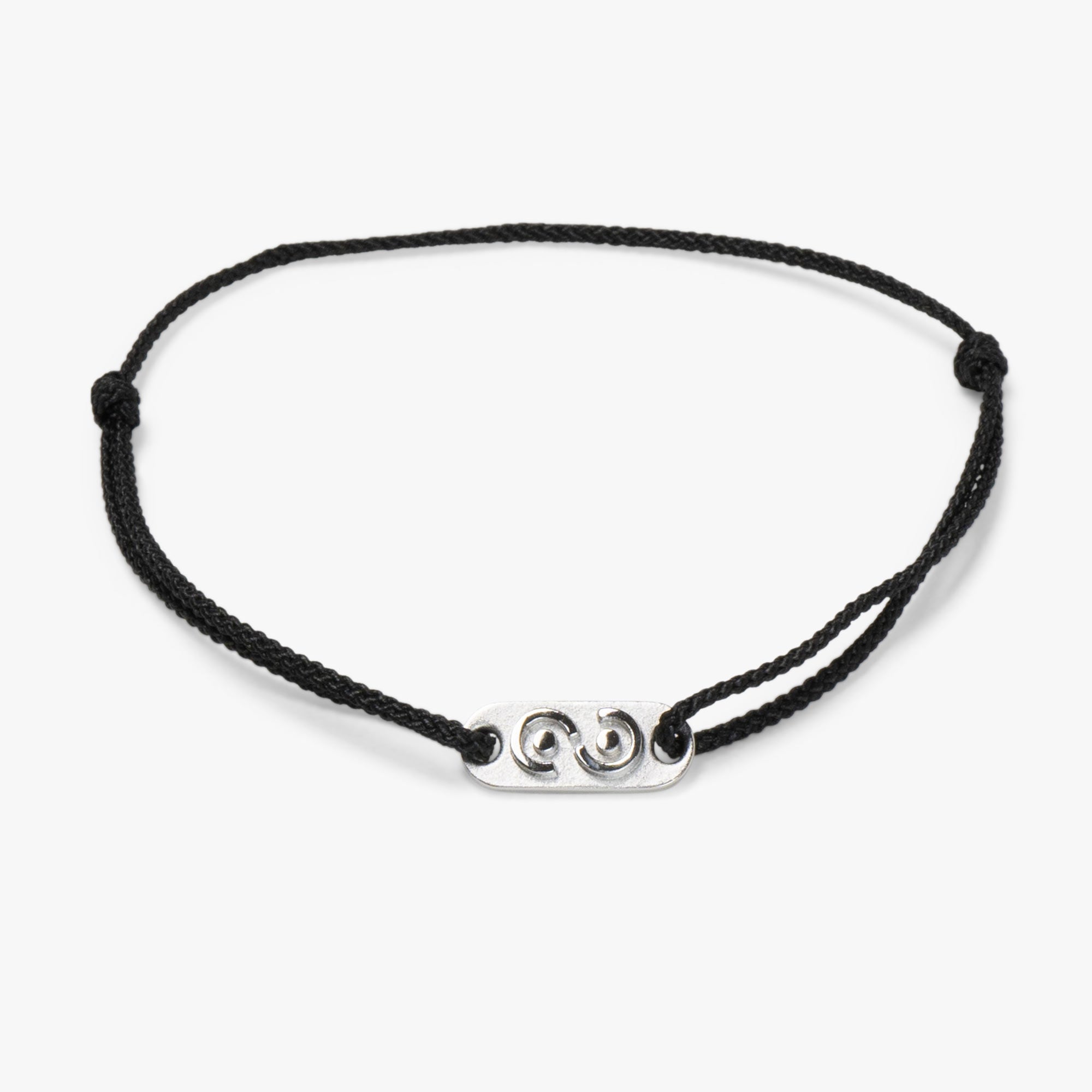 An adjustable black bracelet with a silver tag featuring an abstract design of the infinity symbol and a hand shaking hands.