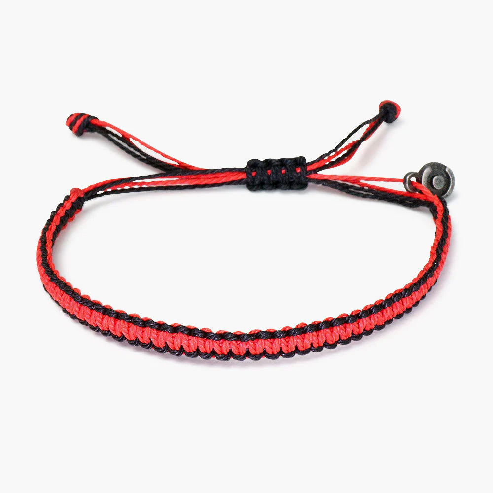 A red and black woven bracelet with a gunmetal charm, adjustable ties at the ends.