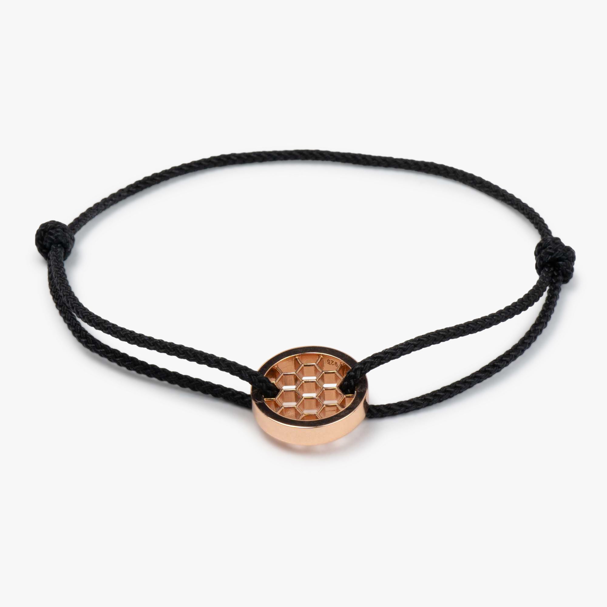 Black golf bracelet with a rose gold plated circular charm, displayed on a white background.