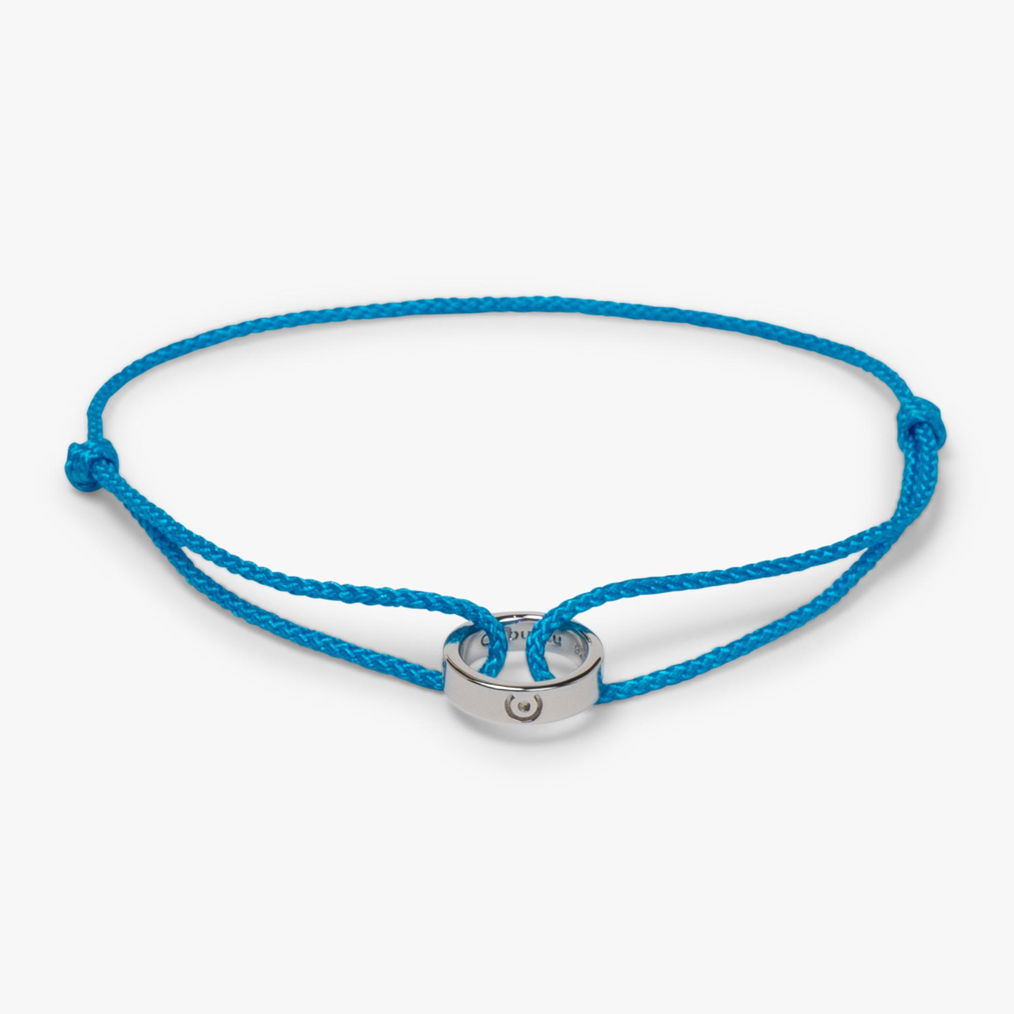 silver ring on blue thread bracelet