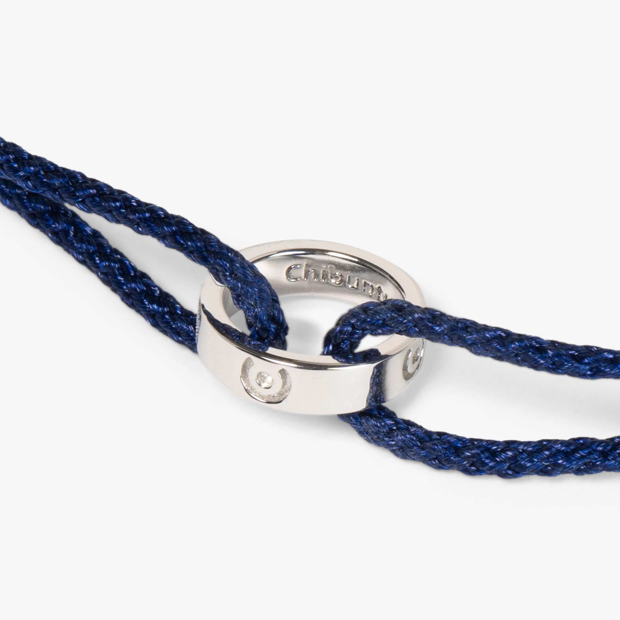 silver ring bracelet on blue thread