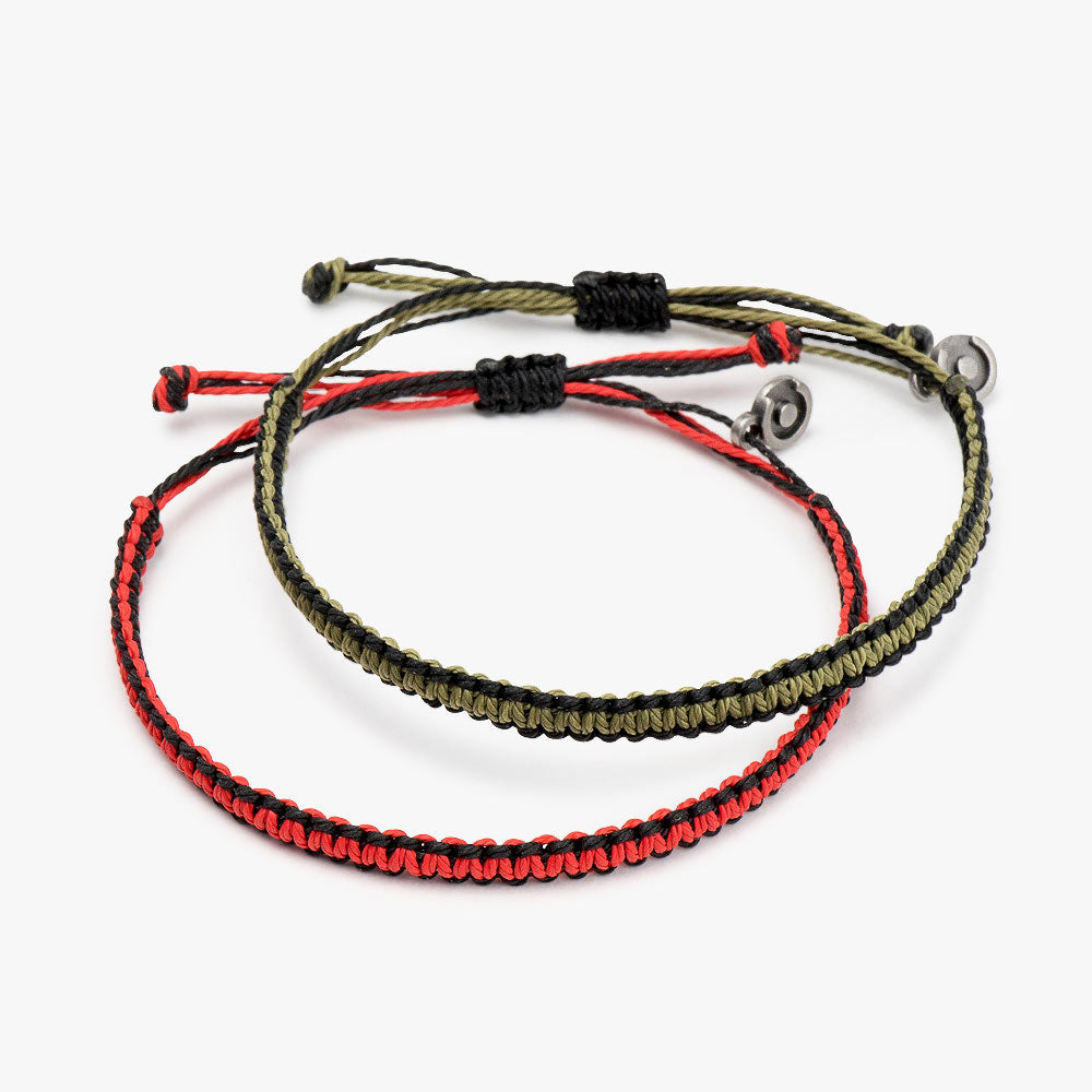 Two wax-coated polyester Cobra bracelets, one red and one green, with gunmetal charms, displayed against a white background.