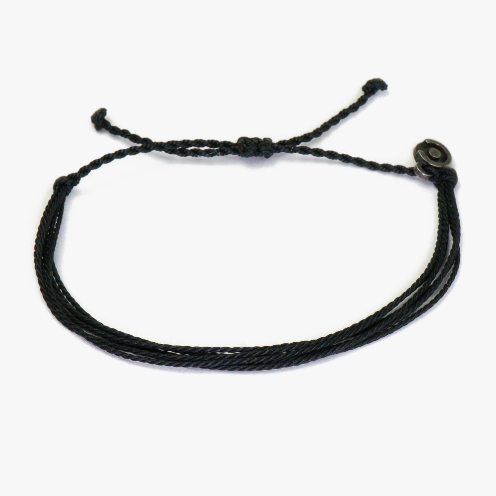 A black wax-coated polyester string bracelet with a Chibuntu power pose charm, displayed on a white background.