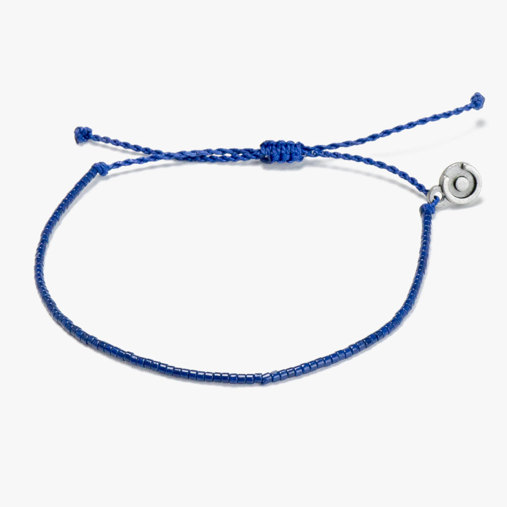 A navy blue beaded bracelet with a Chibuntu power pose charm, displayed against a white background.