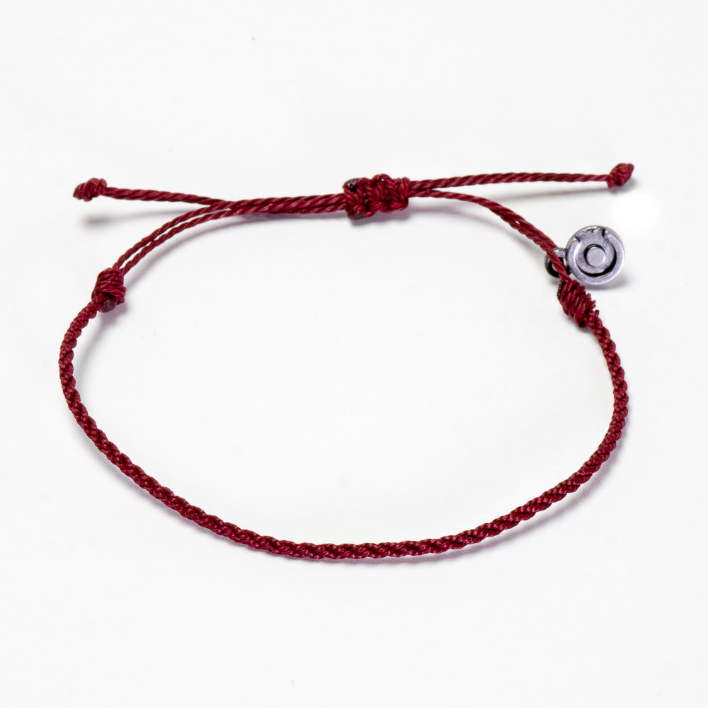A red twisted bracelet with a gunmetal charm, displayed against a white background.