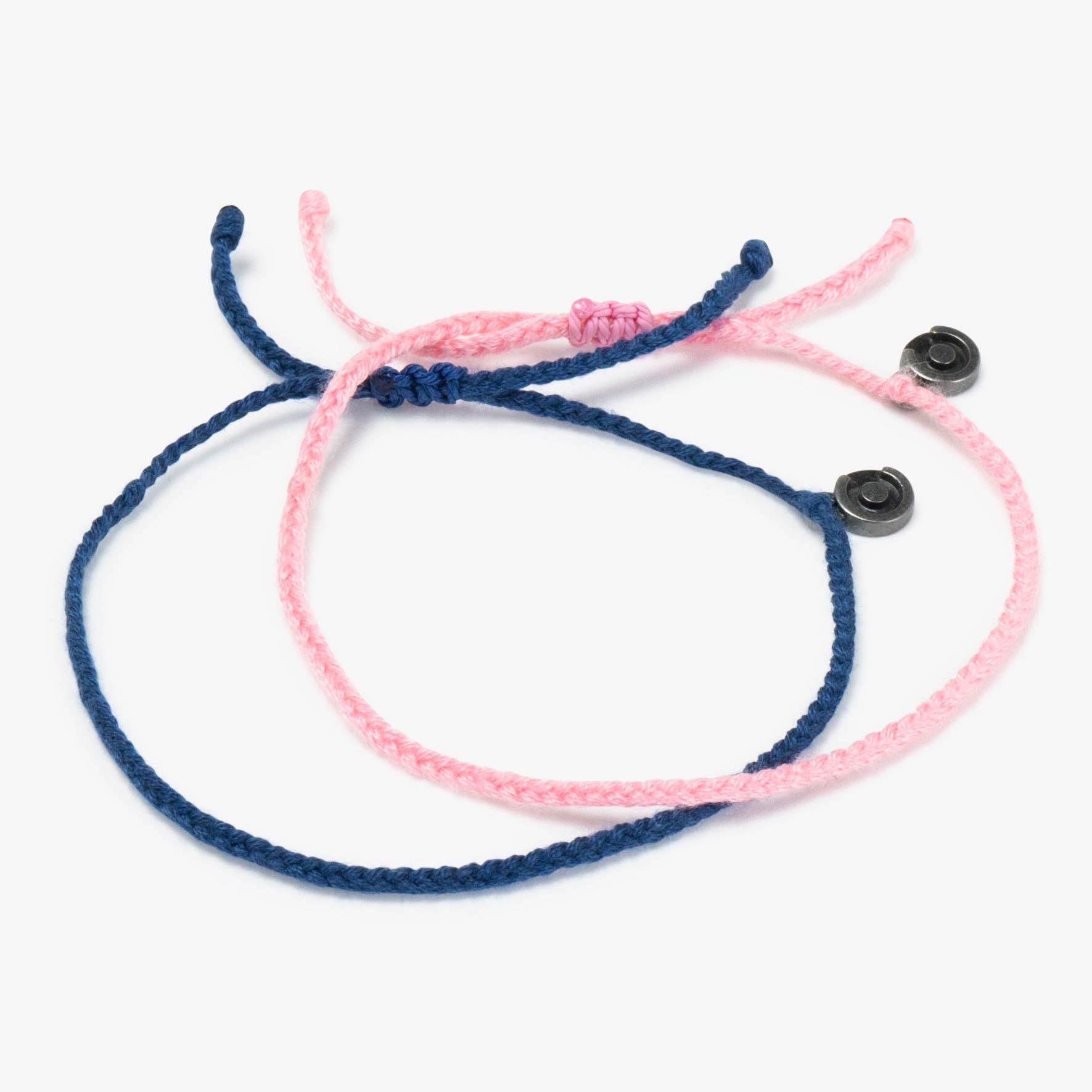 Two bracelets, one pink and one blue, with Chibuntu charms to feel the connection, displayed on a white background.
