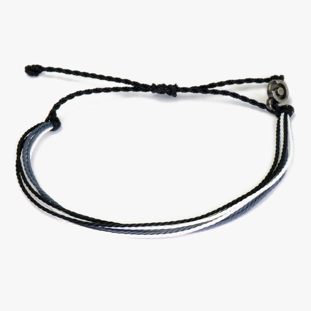A black and blue wax-coated polyester bracelet with a Chibuntu charm, designed to be adjustable.