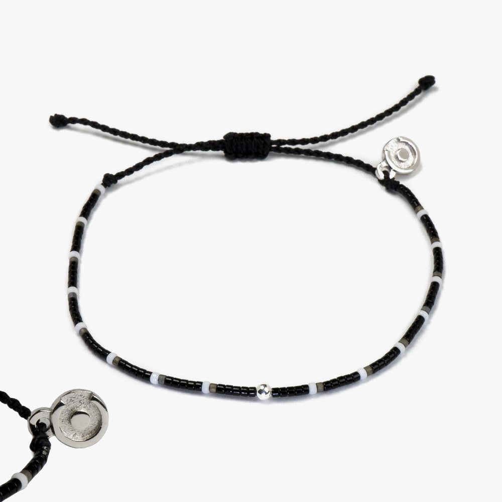 A black and silver beaded bracelet featuring a 925 Sterling Silver Power Pose charm, displayed on a white background.