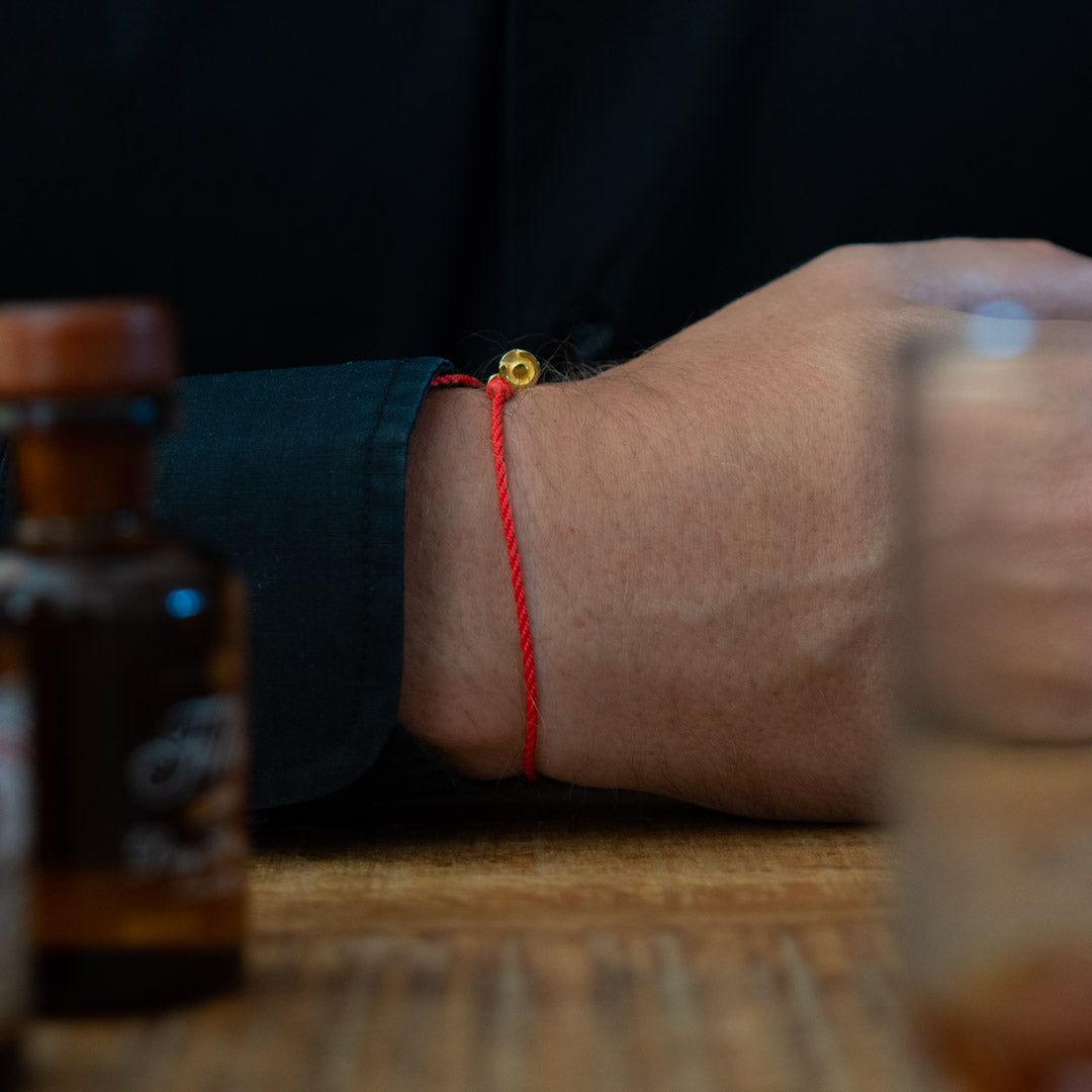 mens red bracelet with 14k gold charm