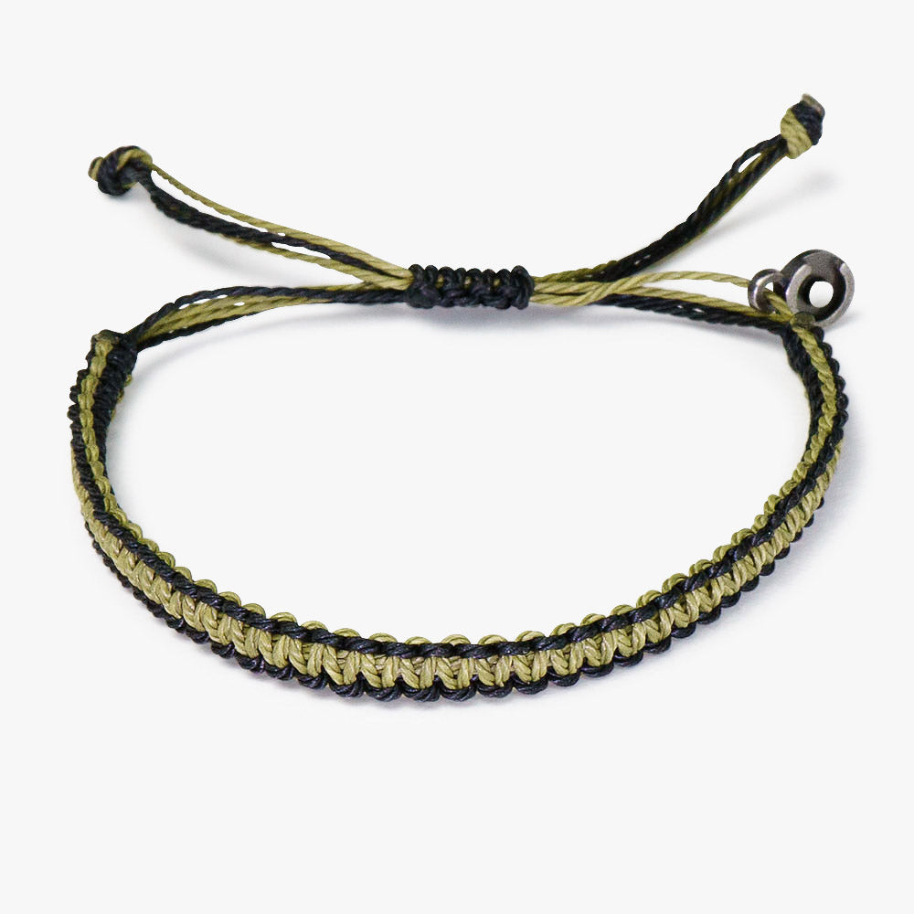 A wax-coated polyester bracelet in green and black, featuring a Chibuntu power pose charm, and an adjustable strap.