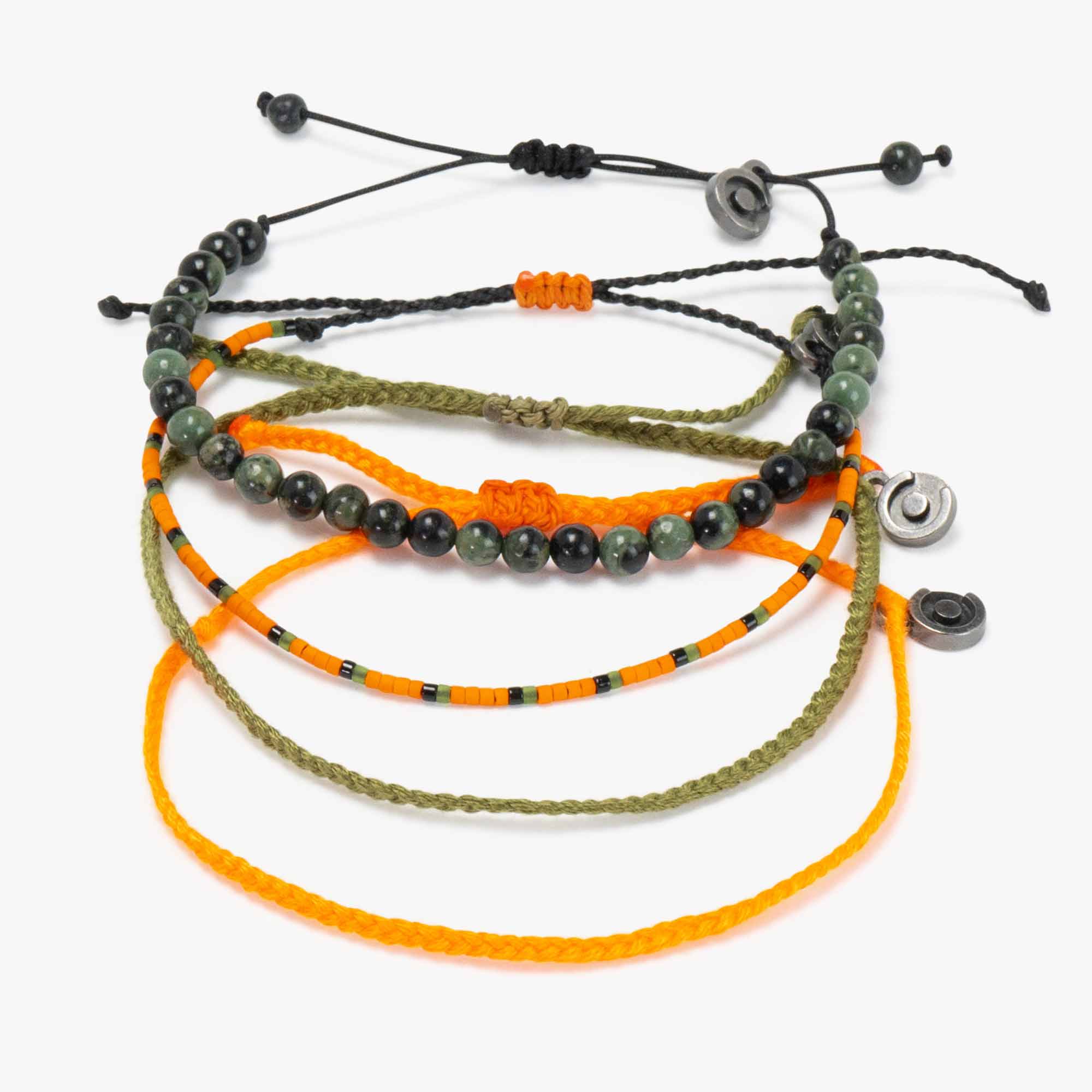 A collection of bracelets laid out together, including one with Moss Agate gemstones and others in orange and green colors with gunmetal charms.