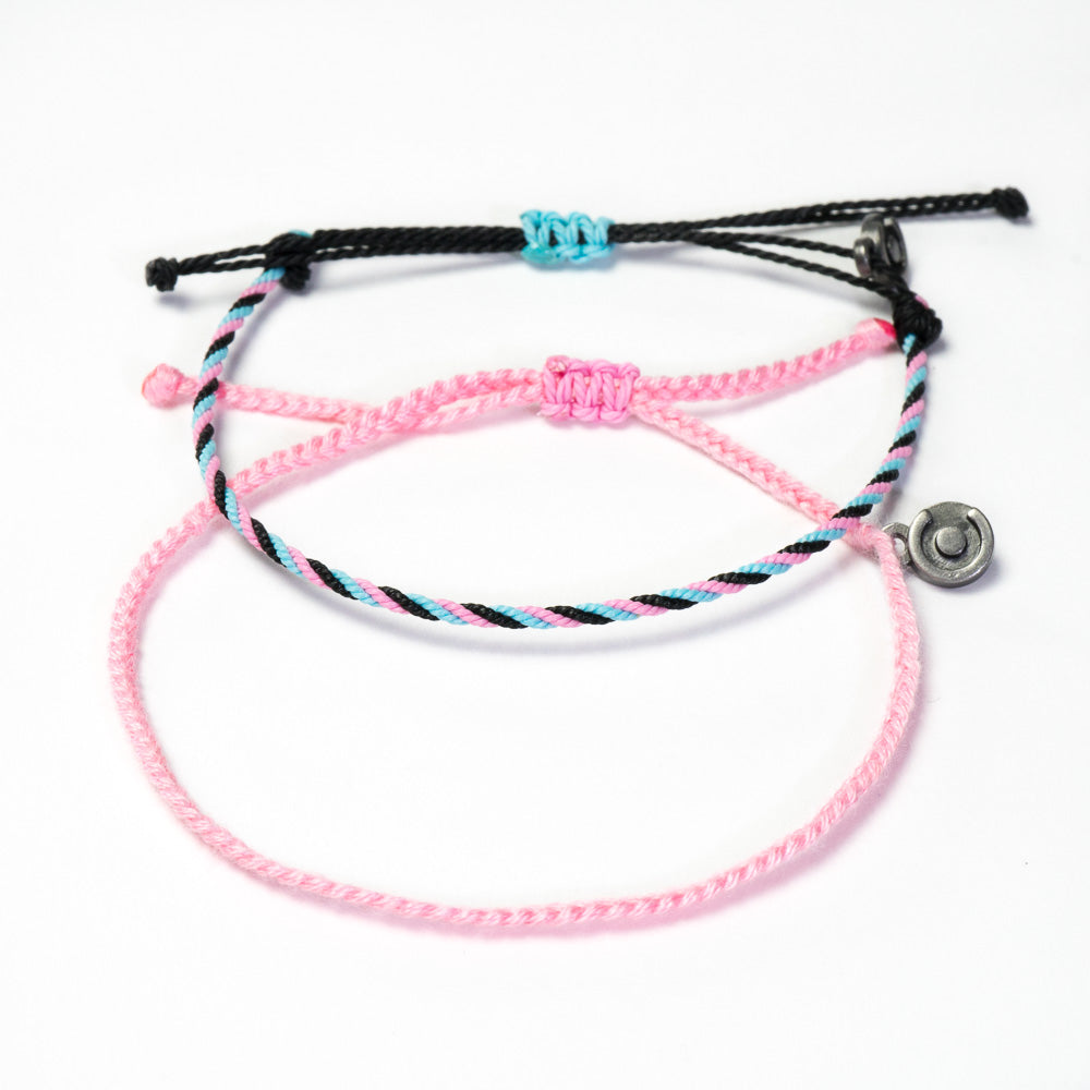 Two woven bracelets, one pink and one black, with a Chibuntu charm, displayed against a white background.
