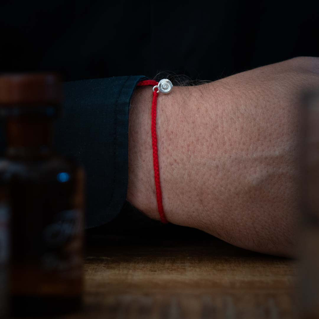 red bracelet diamond like silver charm