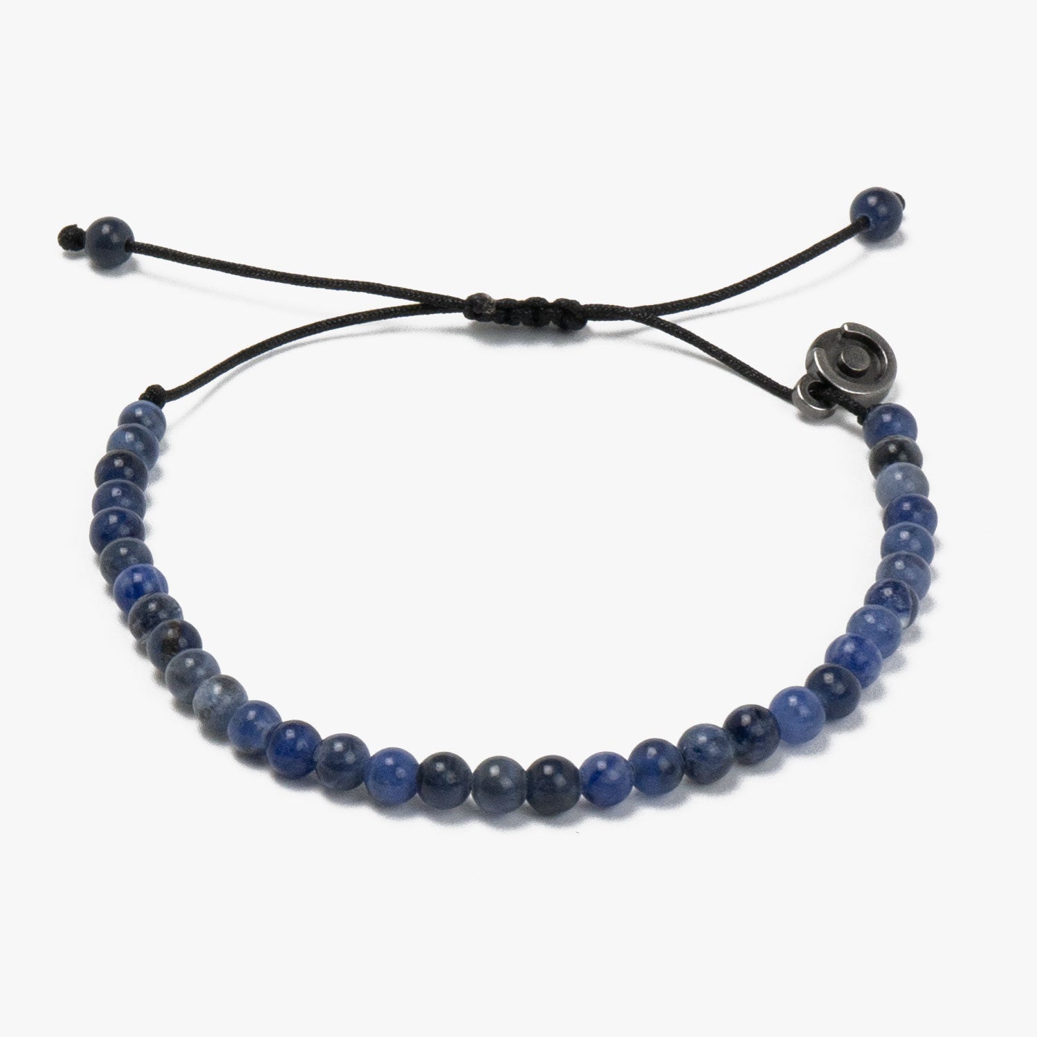 A sodalite gemstone bracelet with gunmetal charm, featuring blue beads and a adjustable black cord.