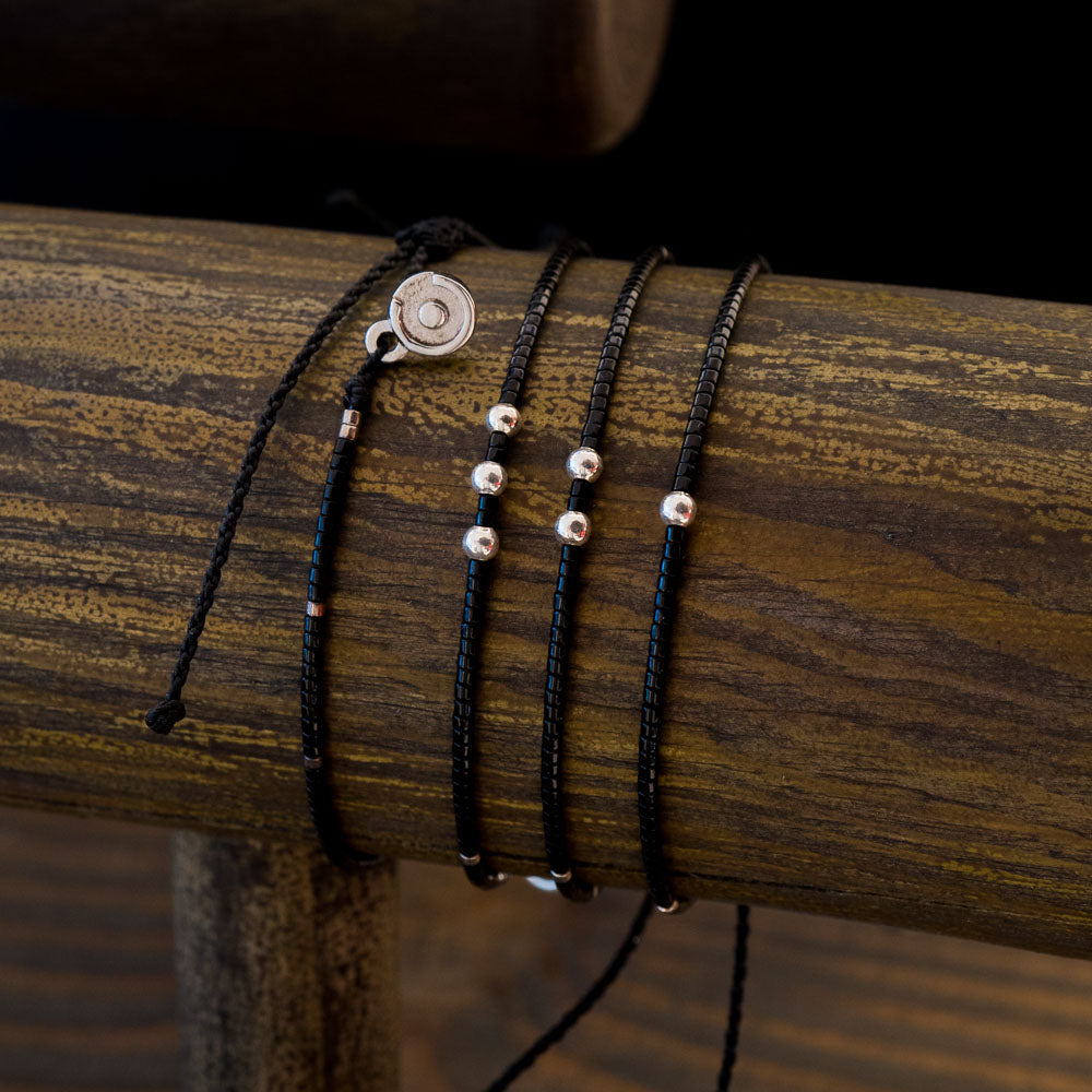 three silver bracelets