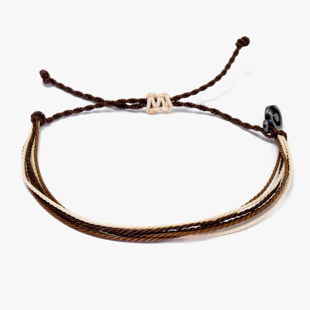 A two-tone brown and beige wax-coated polyester bracelet with a Chibuntu power pose charm, displayed against a white background.