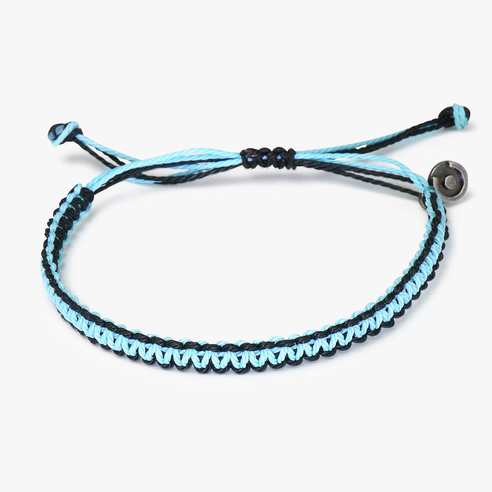 A two-tone (black and blue) woven bracelet with an adjustable strap and a Chibuntu power pose charm.